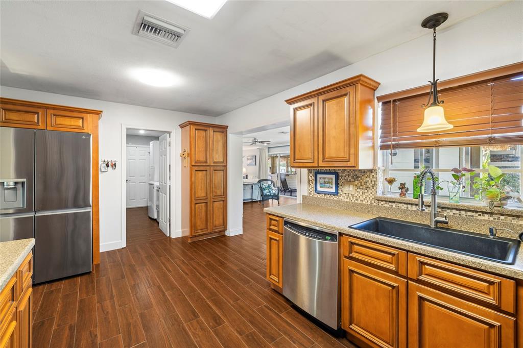 5031 Lakewood Road Sebring, FL 33875 - Photo 18 of 77 a kitchen with stainless steel appliances granite countertop a sink a stove and a refrigerator