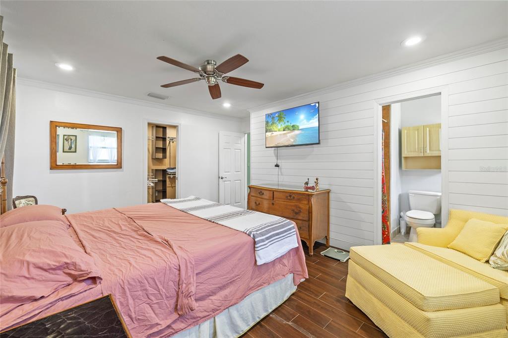 5031 Lakewood Road Sebring, FL 33875 - Photo 23 of 77 a bedroom with a bed and a chandelier