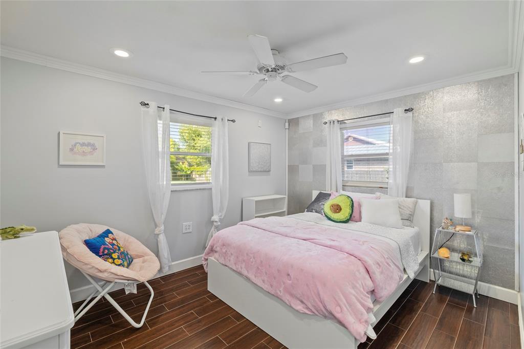 5031 Lakewood Road Sebring, FL 33875 - Photo 27 of 77 a bedroom with a bed and wooden floor