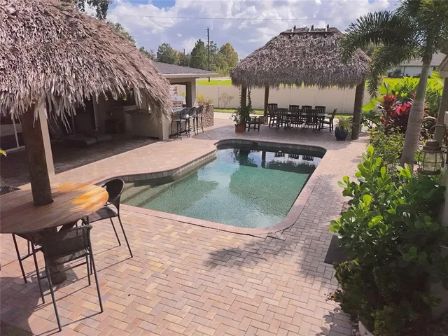 an aerial view of a house with garden space and a patio