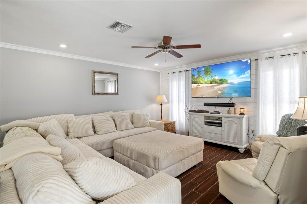 5031 Lakewood Road Sebring, FL 33875 - Photo 39 of 77 a living room with furniture and a flat screen tv