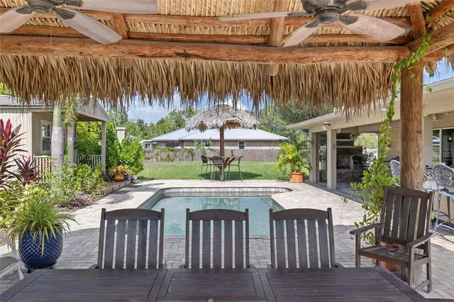 an aerial view of a house with a garden and lake view