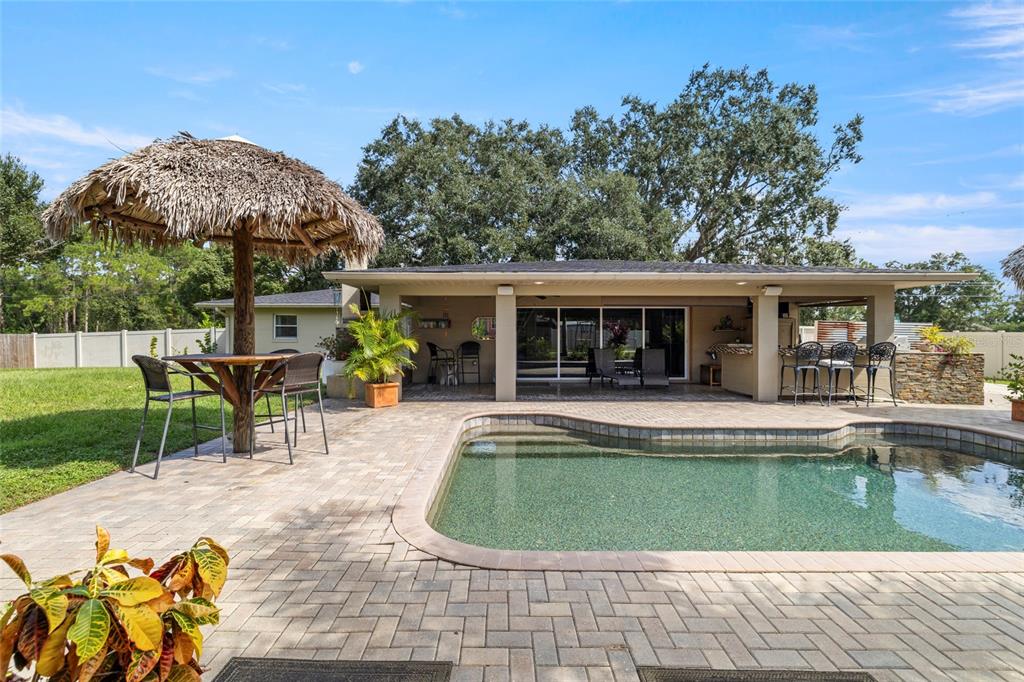 5031 Lakewood Road Sebring, FL 33875 - Photo 56 of 77 a view of a house with a swimming pool and sitting area