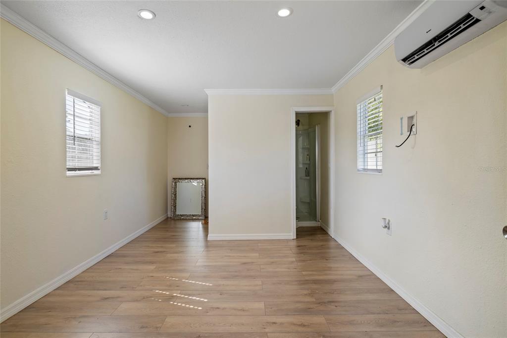 5031 Lakewood Road Sebring, FL 33875 - Photo 59 of 77 a view of an empty room with wooden floor and a window