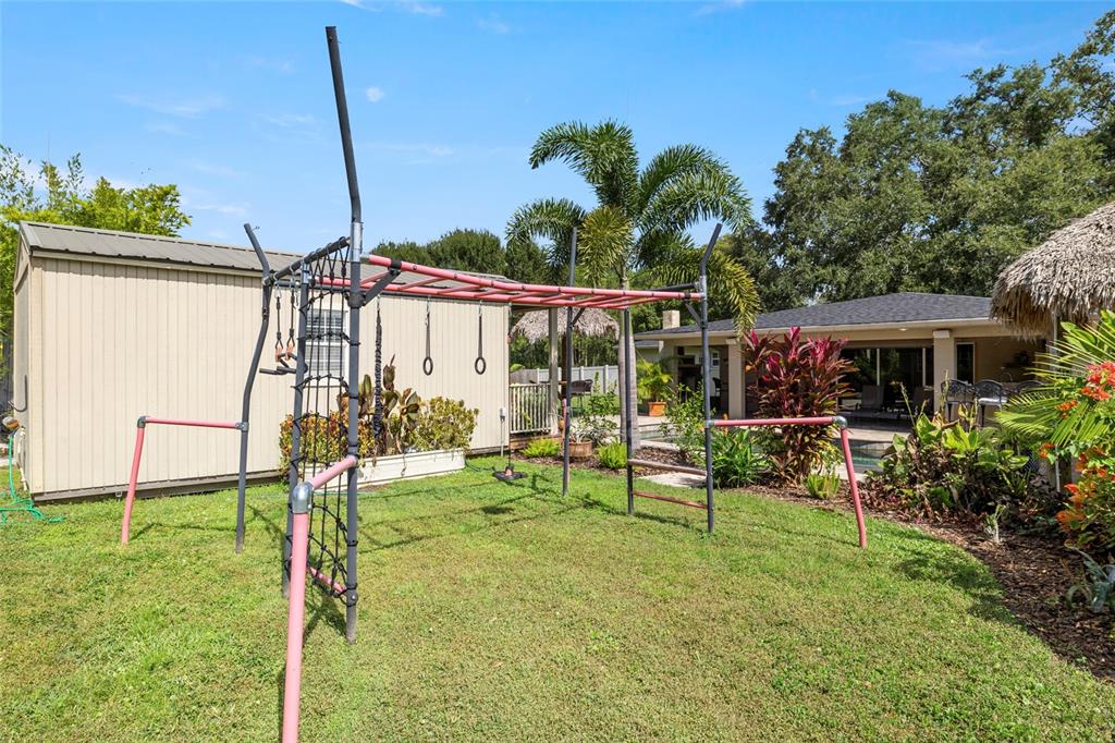 5031 Lakewood Road Sebring, FL 33875 - Photo 62 of 77 a view of house with a backyard and chairs