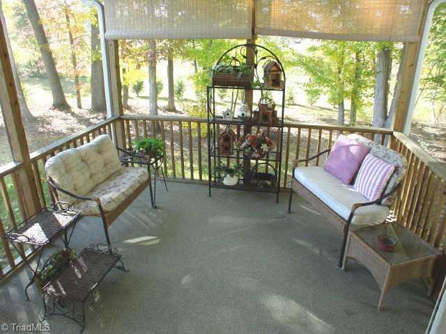 7701 Wilson Farm Road Summerfield, NC 27358 - Photo 8 of 9 Other. Screened porch is ready for relaxing.