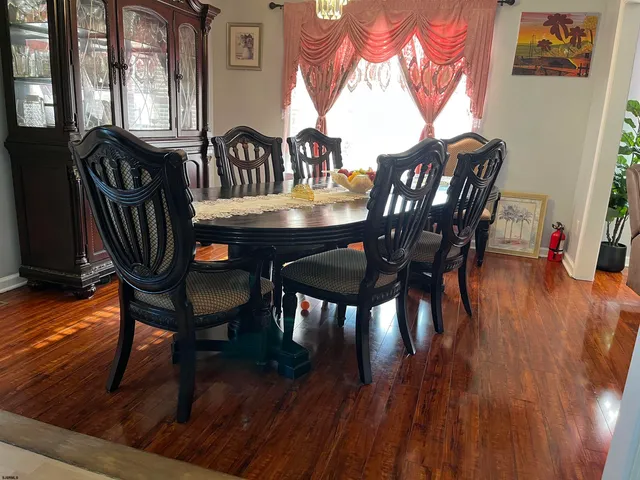 a living room with furniture and large windows