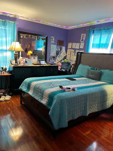 a room with pool table windows and wooden floor