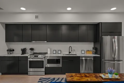 a kitchen with stainless steel appliances wooden cabinets and refrigerator