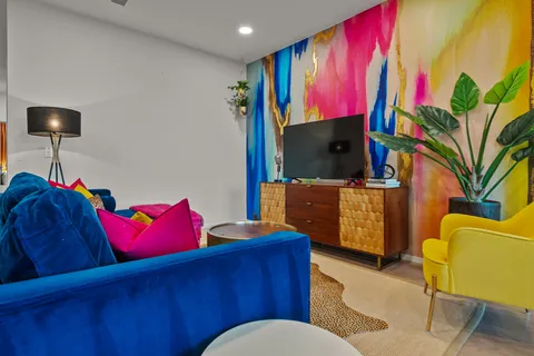 a living room with furniture and a flat screen tv