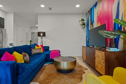 a living room with furniture and a potted plant