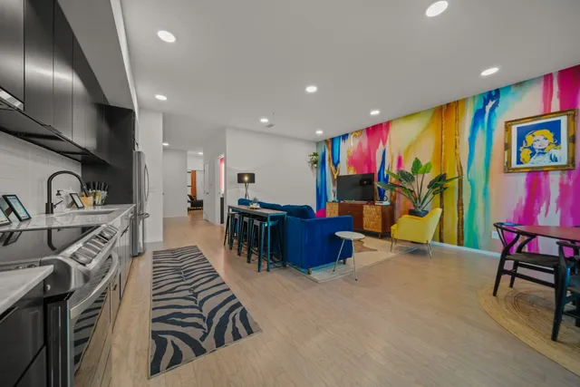 a kitchen with stainless steel appliances kitchen island granite countertop a refrigerator and a sink