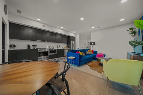a living room with furniture and kitchen view