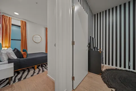 a bedroom with furniture and a large window