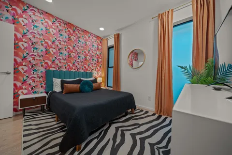 a bedroom with a bed and a window