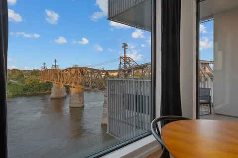 a view of a balcony with furniture and floor to ceiling window