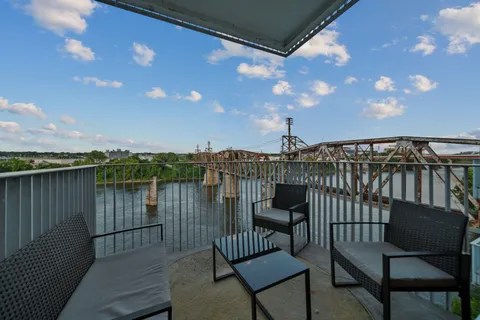 a view of a balcony with furniture