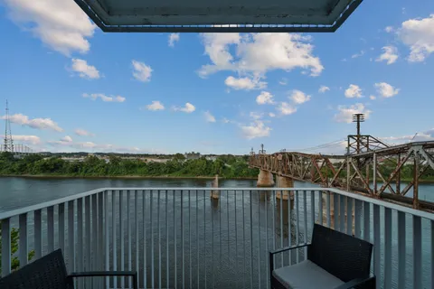 a view of a balcony with wooden floor and city view