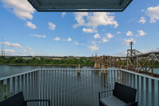 a view of a balcony with wooden floor and city view