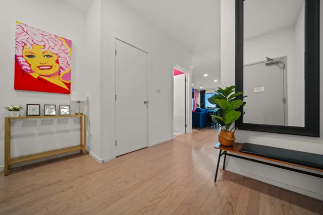 a room with painting on the wall and a potted plant