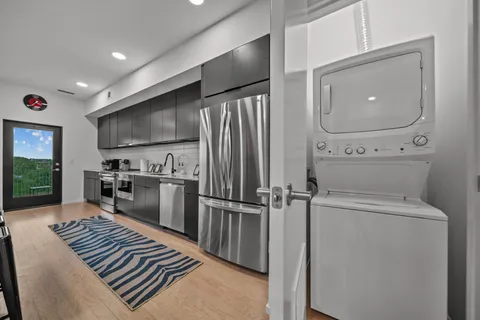 a kitchen with sink cabinets and stainless steel appliances