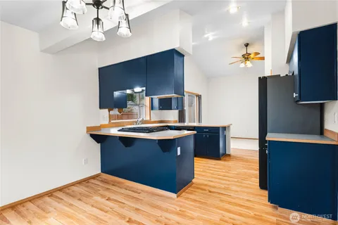 a kitchen with stainless steel appliances granite countertop a sink a stove and a refrigerator