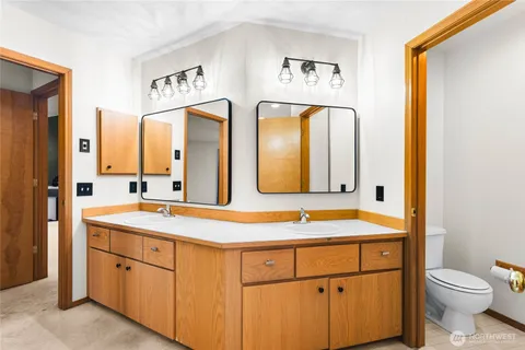 a bathroom with a toilet sink and mirror