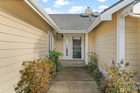 a front view of a house with a garden