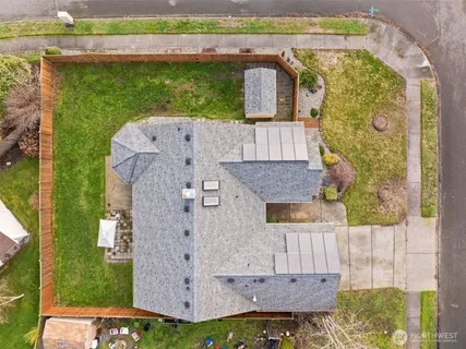 an aerial view of a house with a garden and large tree