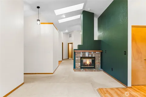 a view of empty room with a fireplace
