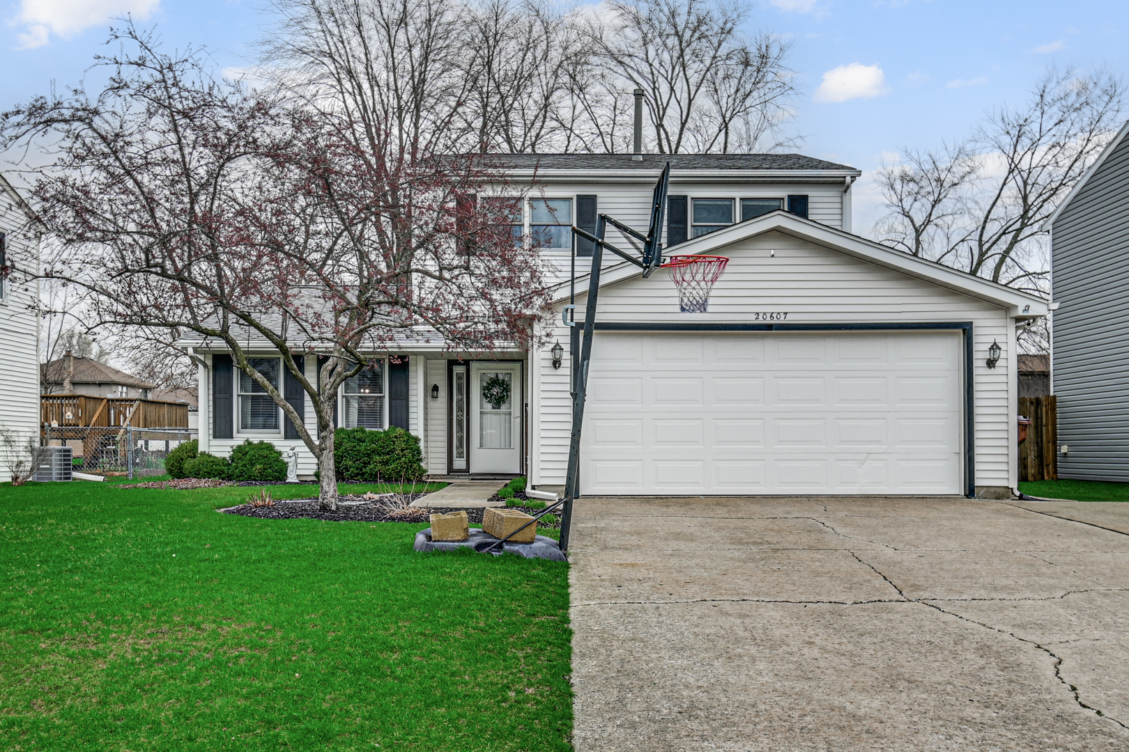 20607 South Acorn Ridge Drive Frankfort, IL 60423 - Photo 1 of 18 a front view of a house with a garden and trees
