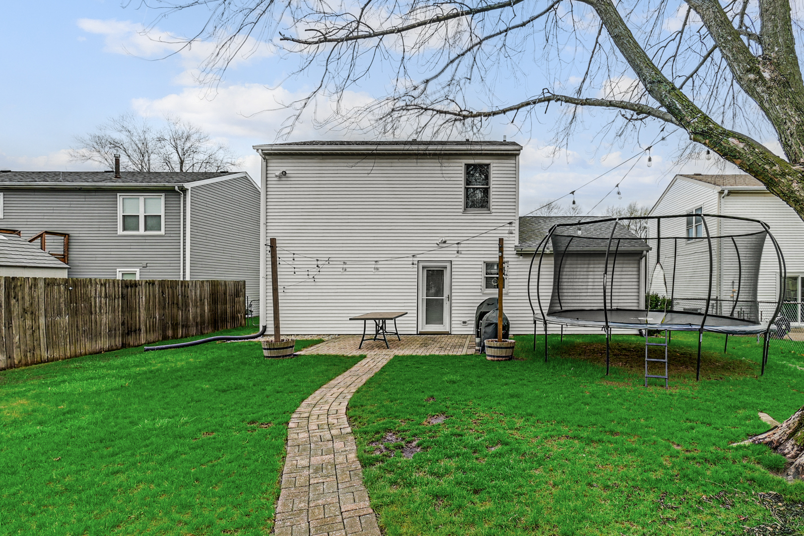 20607 South Acorn Ridge Drive Frankfort, IL 60423 - Photo 17 of 18 a view of a backyard with table and chairs and wooden fence