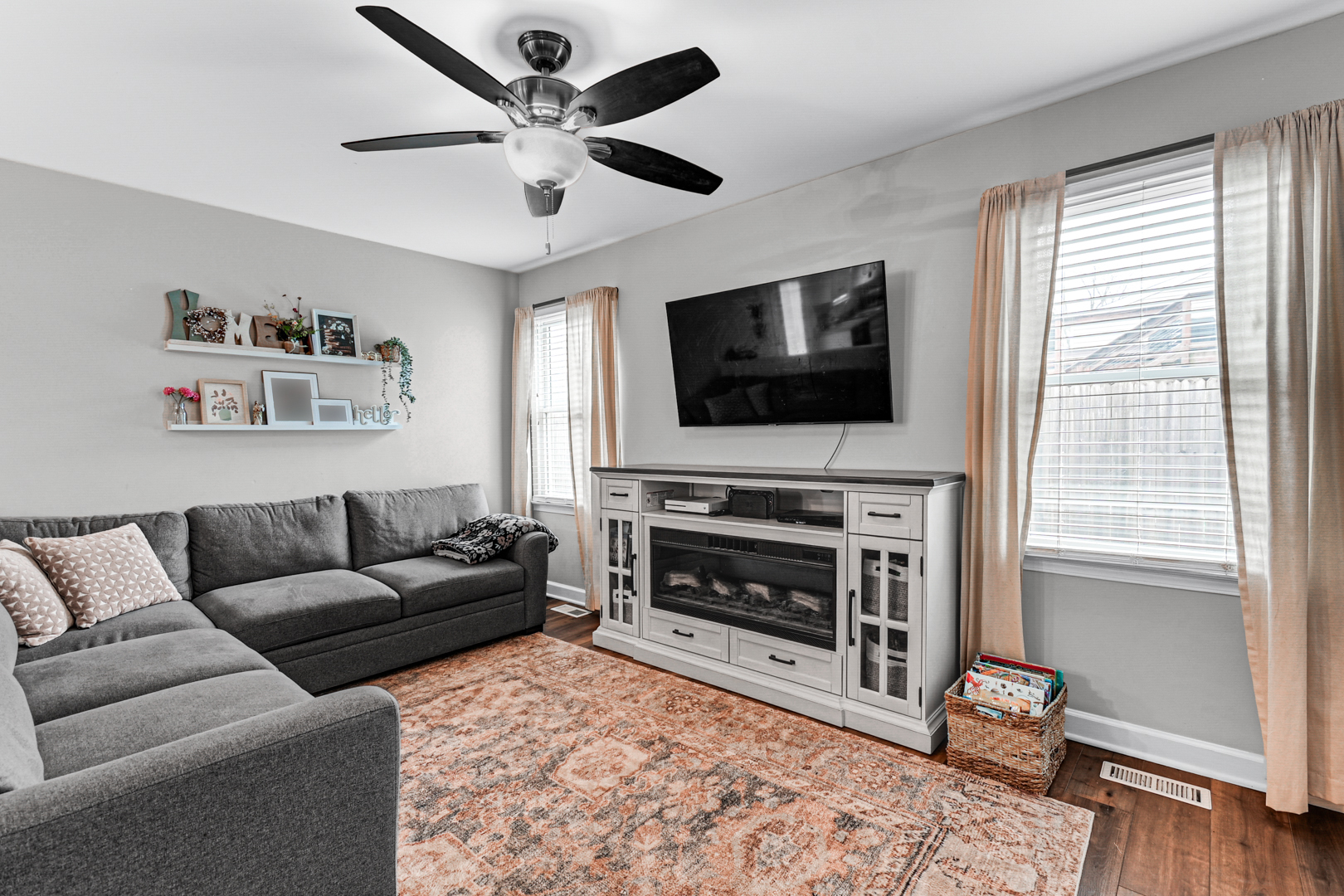 20607 South Acorn Ridge Drive Frankfort, IL 60423 - Photo 10 of 18 a living room with furniture a flat screen tv and a fireplace
