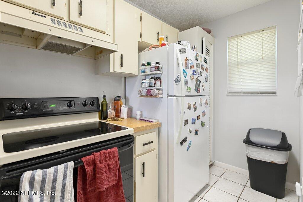 700 West Pope Road, Unit A6 St. Augustine, FL 32080 - Photo 13 of 25 a kitchen with stainless steel appliances granite countertop a refrigerator and a stove