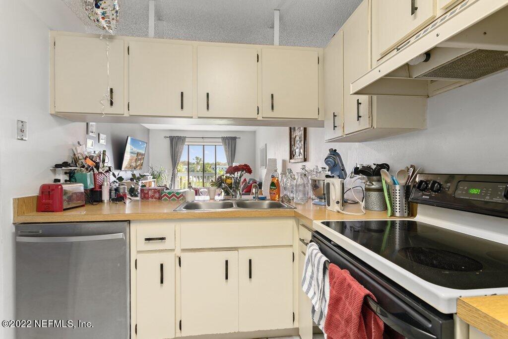 700 West Pope Road, Unit A6 St. Augustine, FL 32080 - Photo 14 of 25 a kitchen with a sink and cabinets