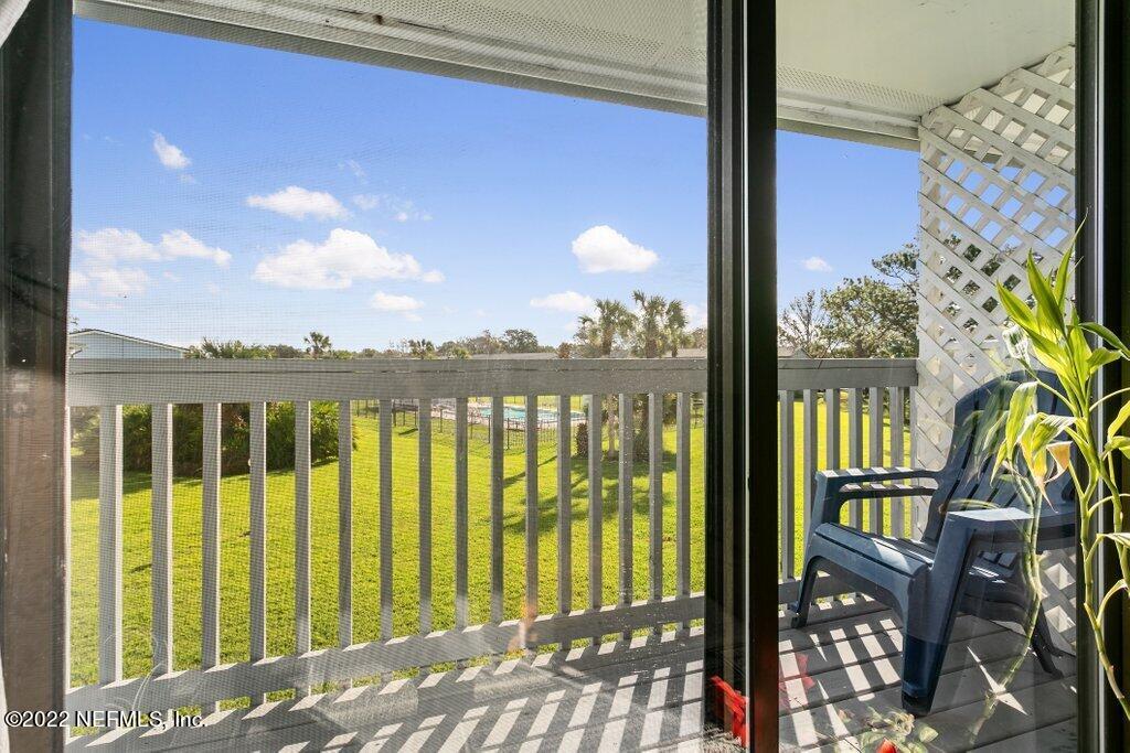700 West Pope Road, Unit A6 St. Augustine, FL 32080 - Photo 6 of 25 a view of a balcony with wooden floor & fence
