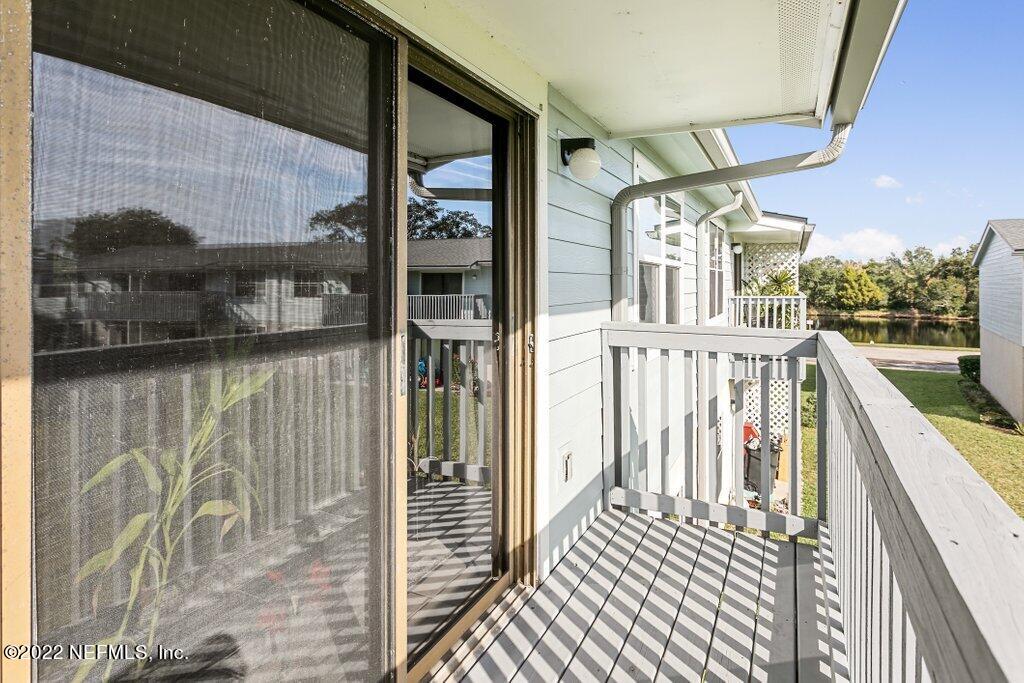 700 West Pope Road, Unit A6 St. Augustine, FL 32080 - Photo 10 of 25 a view of a balcony with wooden floor and door