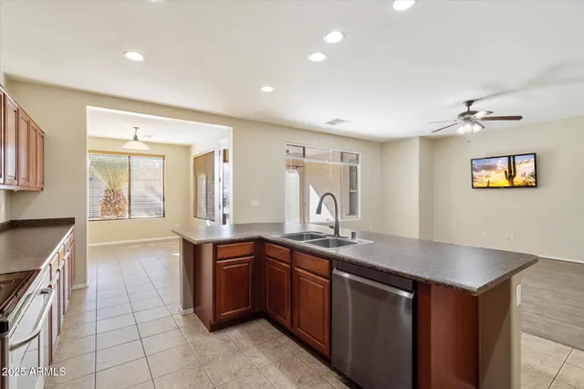 a large kitchen with stainless steel appliances a sink and cabinets