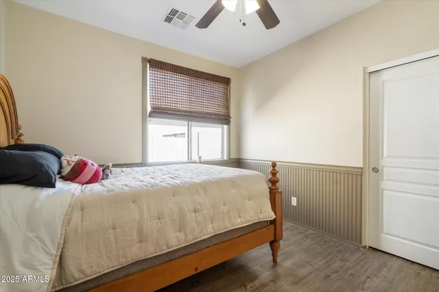a bedroom with a bed and a chandelier