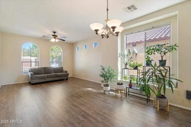 a living room with furniture and a chandelier