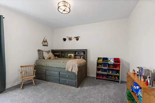 a bedroom with a bed and a book shelf