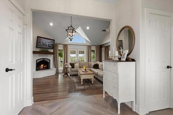 a living room with furniture a fireplace and a flat screen tv
