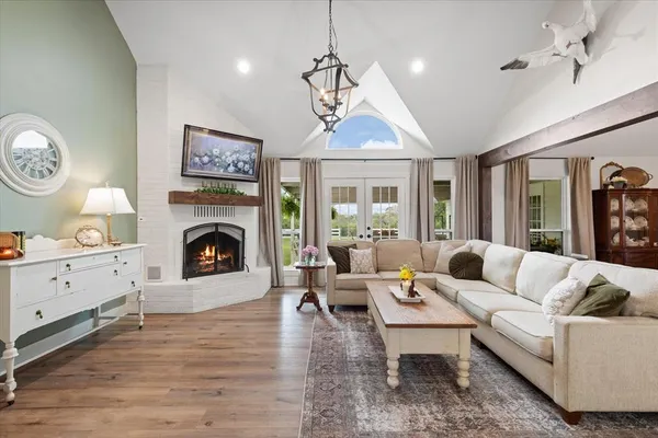 a living room with furniture a fireplace and a window