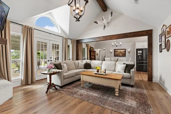 a living room with furniture and a wooden floor