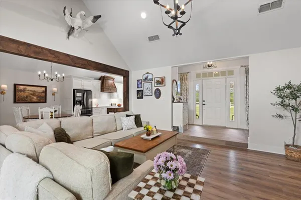 a living room with furniture and a chandelier