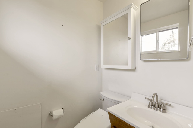 447 550 South Bountiful, UT 84010 - Photo 11 of 25 Bathroom featuring a wood-finish vanity with an integrated sink and brushed nickel faucet, a medicine cabinet, and a framed mirror