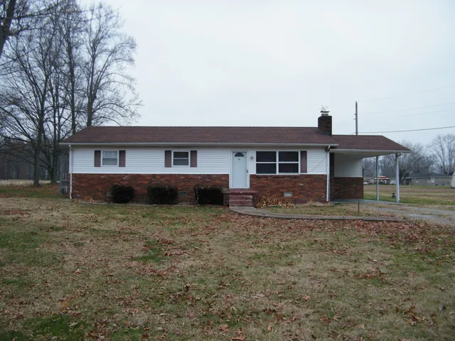 a front view of a house with trees