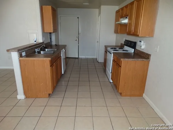 a kitchen with a sink a stove and a microwave