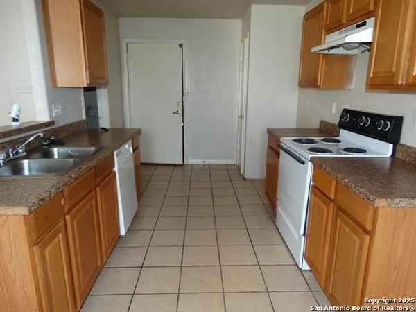 a kitchen with a sink a stove and a cabinets