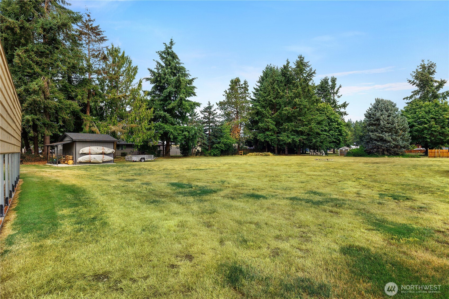 8336 178th Avenue Southwest Rochester, WA 98579 - Photo 21 of 39 a swimming pool that has lawn chairs with wooden fence